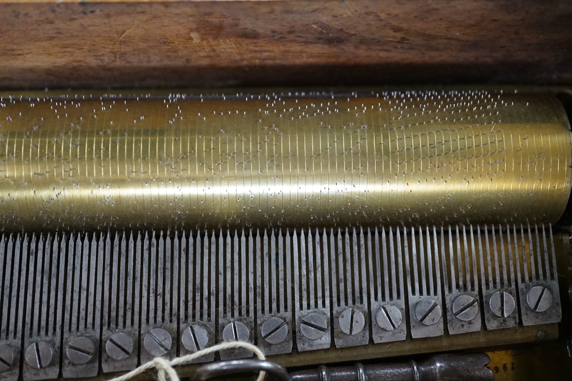 A small mid 19th century Swiss musical box in a bird’s eye maple case, side key wound, 30cm wide. Condition - fair.